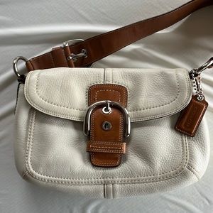 Ivory pebbled leather shoulder bag from Coach.